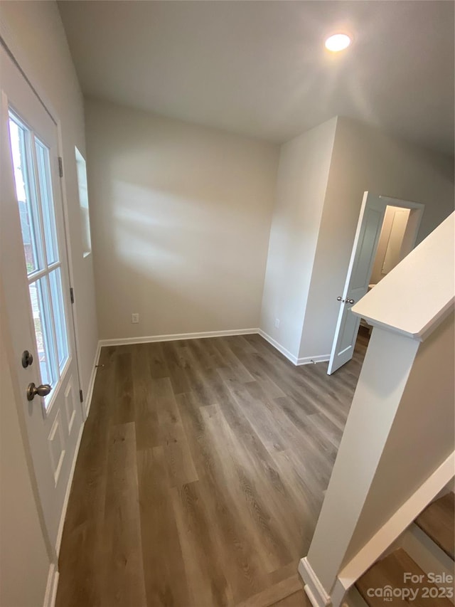 interior space with plenty of natural light and dark hardwood / wood-style flooring