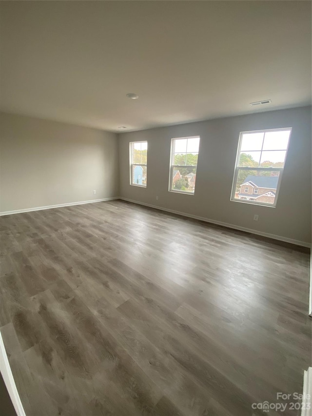 empty room with dark hardwood / wood-style floors