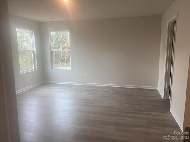 spare room with dark hardwood / wood-style floors