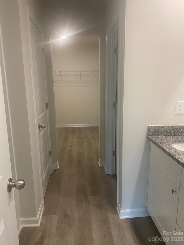 corridor with sink and dark hardwood / wood-style flooring