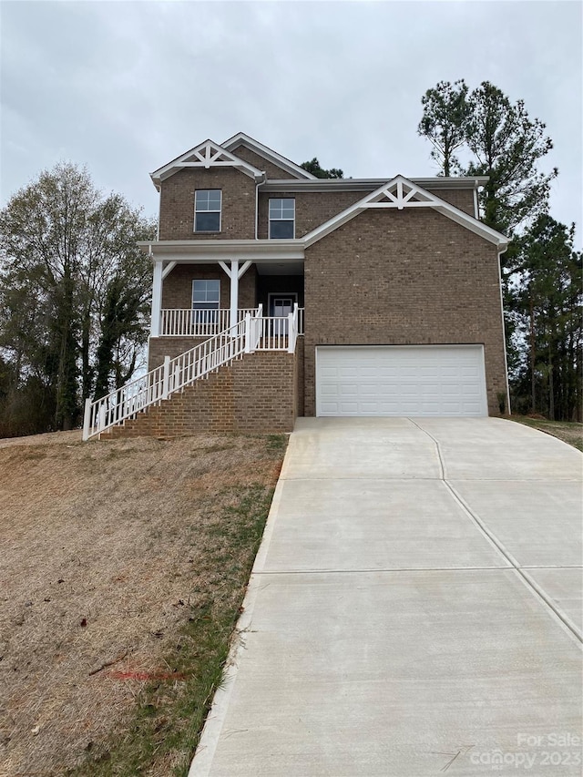 craftsman-style house with a porch and a garage