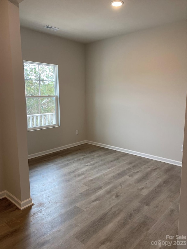 unfurnished room featuring dark wood-type flooring