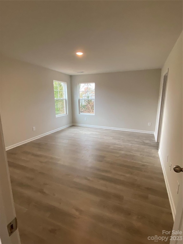 empty room featuring dark wood-type flooring