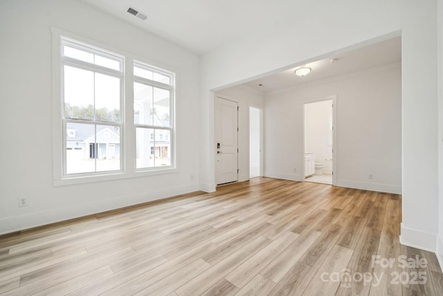 spare room featuring light hardwood / wood-style flooring and ornamental molding