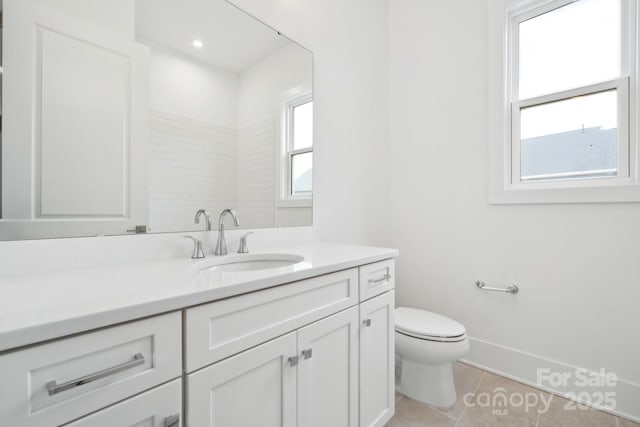 bathroom featuring vanity, tile patterned floors, and toilet