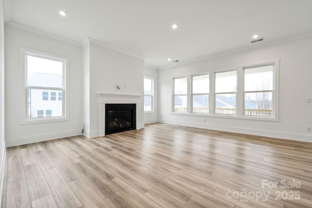 unfurnished living room featuring crown molding and light hardwood / wood-style floors