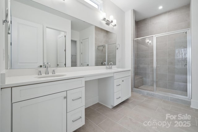 bathroom featuring vanity, an enclosed shower, and tile patterned flooring