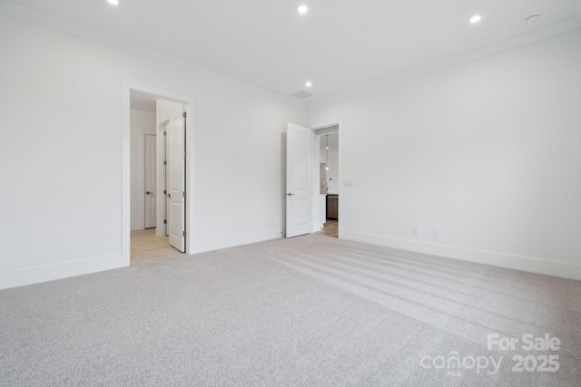 unfurnished bedroom featuring crown molding and light carpet