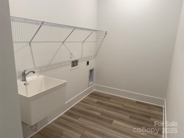 laundry room with dark wood-type flooring, washer hookup, sink, and electric dryer hookup