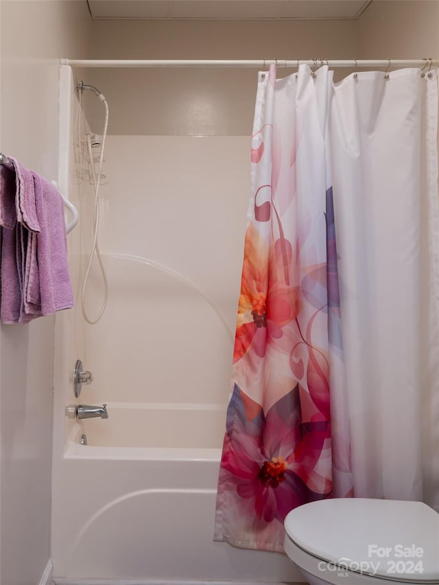 bathroom with toilet and shower / bath combo