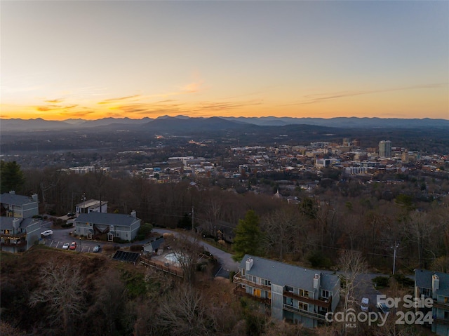 aerial view at dusk featuring a mountain view