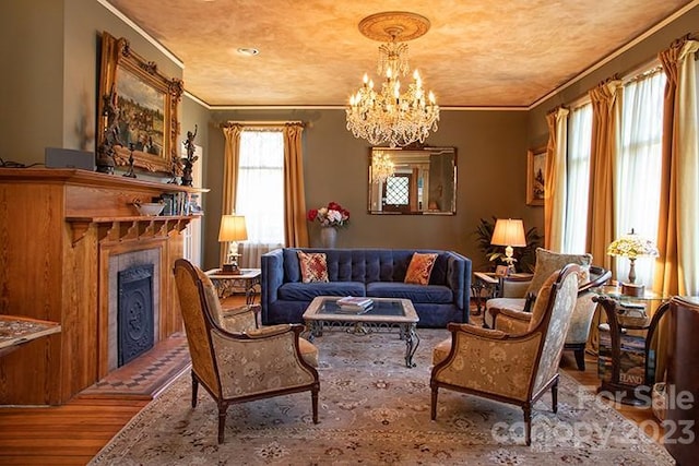 sitting room with ornamental molding, a chandelier, and light wood-type flooring