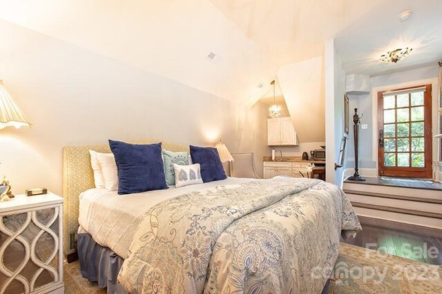 bedroom featuring vaulted ceiling and light hardwood / wood-style floors