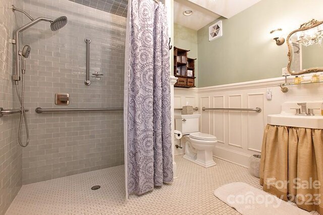 bathroom featuring sink, toilet, tile patterned floors, and a shower with shower curtain