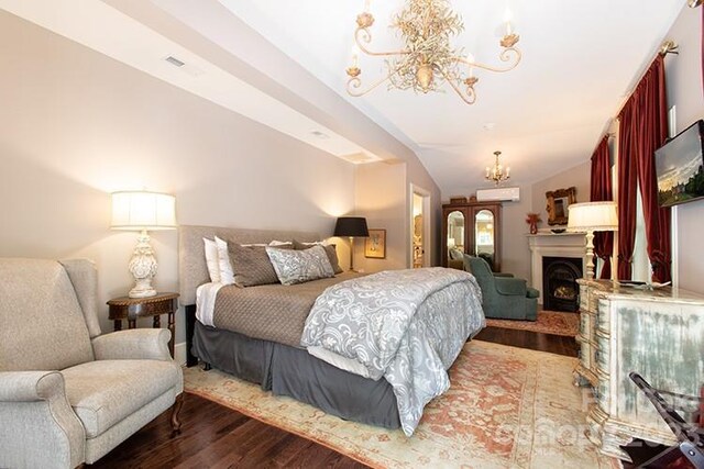 bedroom with vaulted ceiling, a chandelier, and dark wood-type flooring