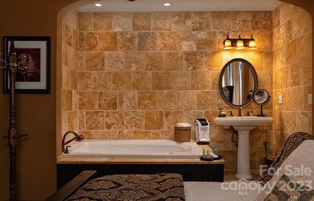 bathroom with tiled bath