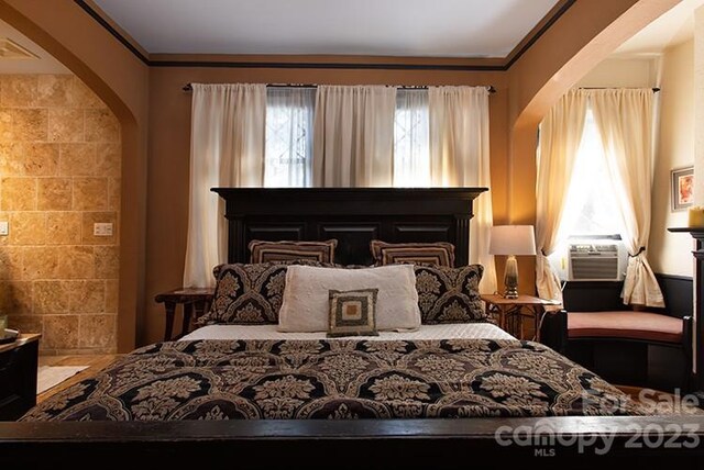 bedroom featuring cooling unit and ornamental molding