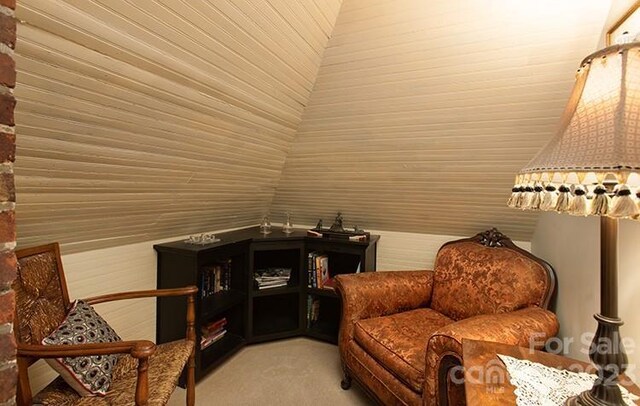 living area featuring carpet floors and lofted ceiling