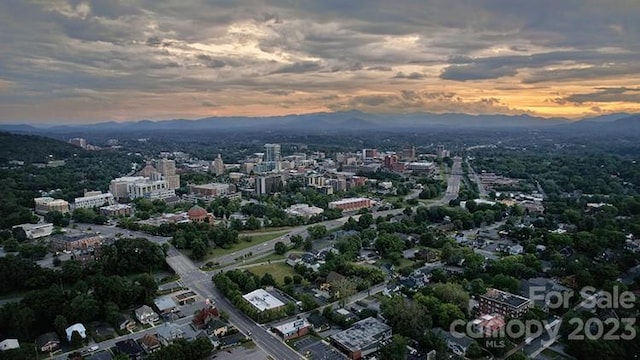 aerial view at dusk featuring a mountain view