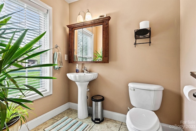 bathroom with toilet and tile patterned flooring