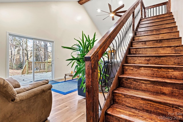 stairway featuring beamed ceiling, high vaulted ceiling, ceiling fan, and hardwood / wood-style flooring