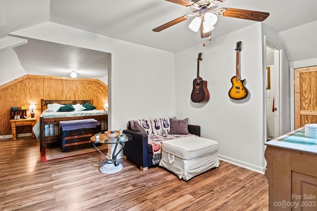 bedroom featuring ceiling fan, wood-type flooring, and lofted ceiling