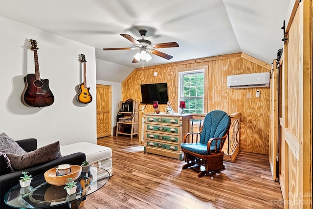 sitting room with ceiling fan, wooden walls, lofted ceiling, and hardwood / wood-style floors