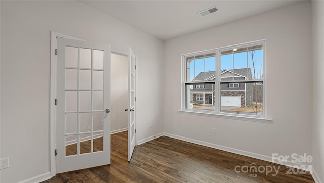 unfurnished room with dark hardwood / wood-style flooring