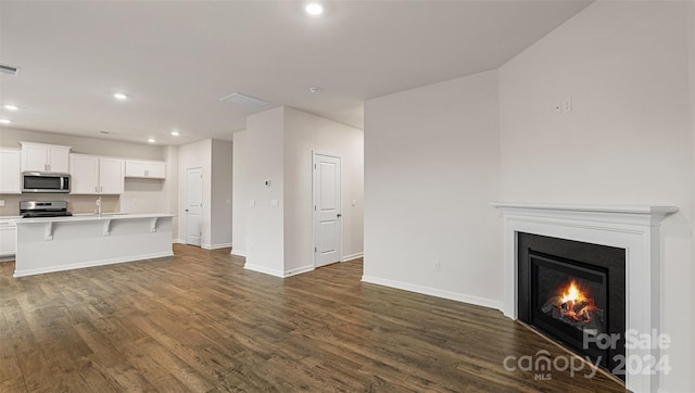 unfurnished living room featuring dark hardwood / wood-style floors