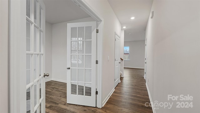 hallway with dark hardwood / wood-style flooring and french doors