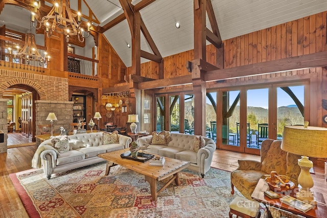 living room featuring light hardwood / wood-style floors, french doors, a mountain view, and high vaulted ceiling