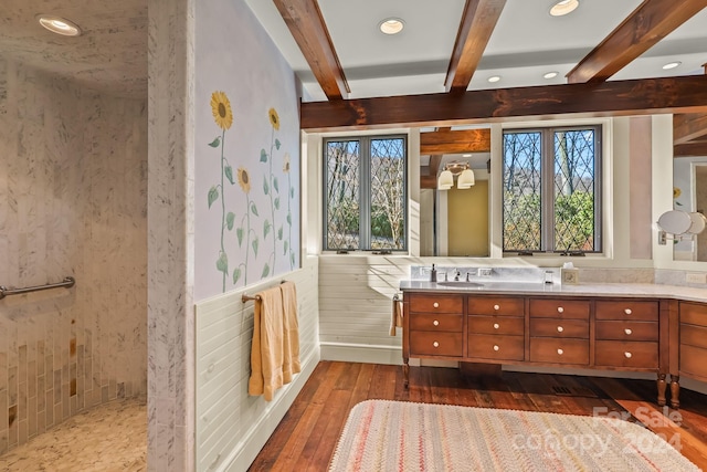 bathroom featuring hardwood / wood-style flooring, beamed ceiling, and vanity