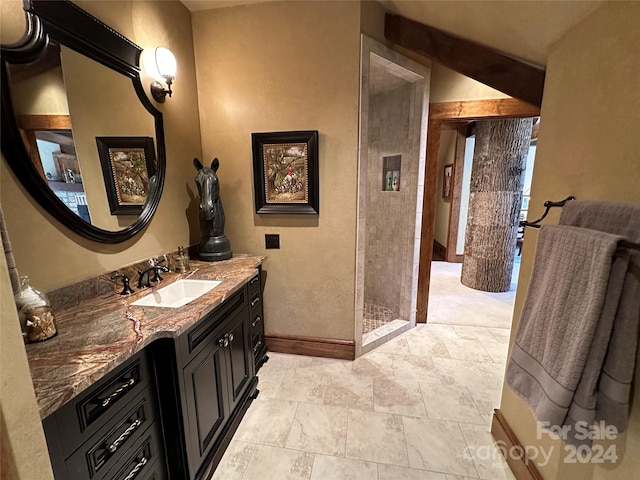 bathroom with walk in shower, vanity, and vaulted ceiling