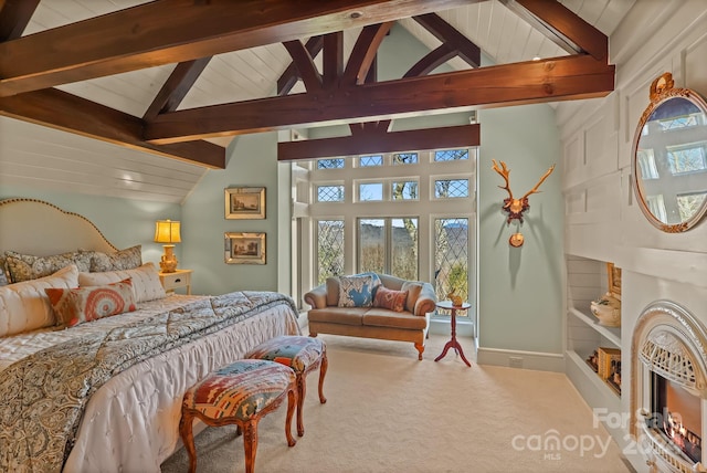 bedroom with beam ceiling, high vaulted ceiling, and carpet