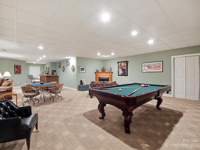 game room with light carpet, pool table, and a paneled ceiling