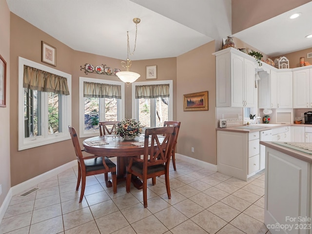 dining room featuring light tile patterned flooring and sink