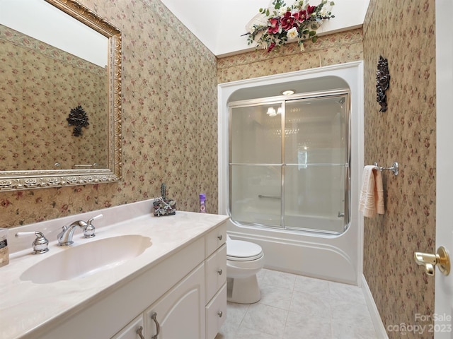 full bathroom featuring tile patterned flooring, toilet, bath / shower combo with glass door, and vanity