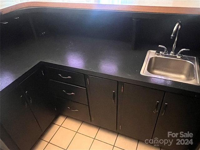 kitchen featuring sink and light tile floors