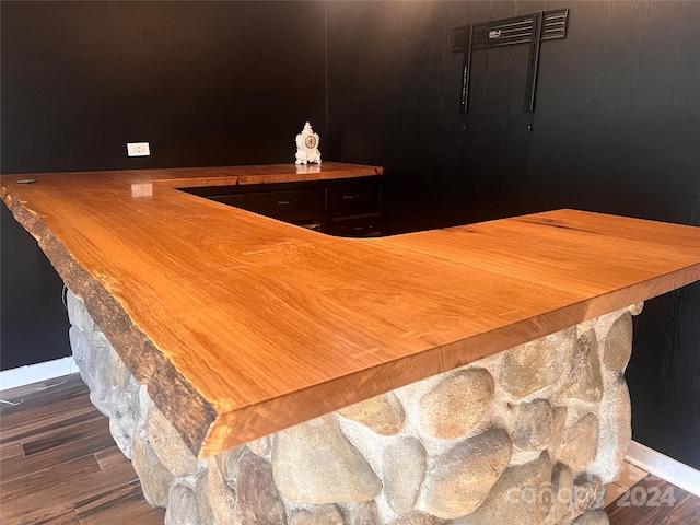 bar with dark wood-type flooring