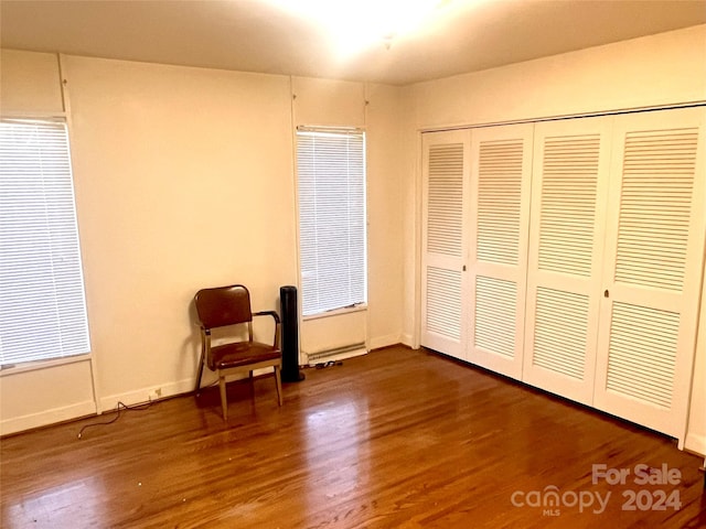 unfurnished room with wood-type flooring