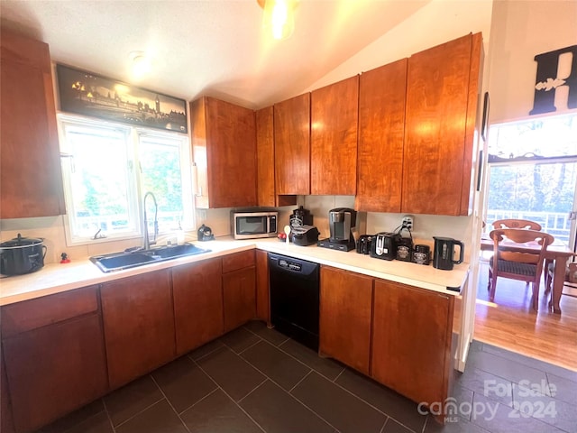 kitchen featuring black dishwasher, dark tile floors, sink, and lofted ceiling