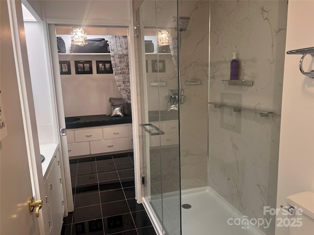 full bath with tile patterned flooring, toilet, connected bathroom, vanity, and a shower stall