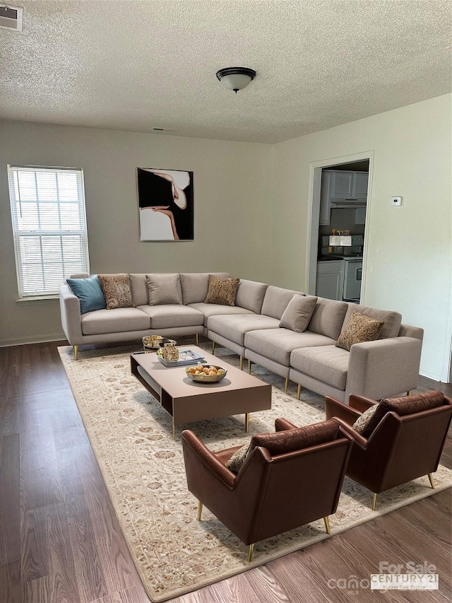 living room featuring hardwood / wood-style flooring and a textured ceiling