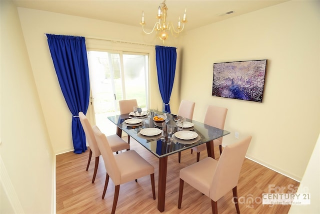 dining room featuring a notable chandelier and light hardwood / wood-style flooring