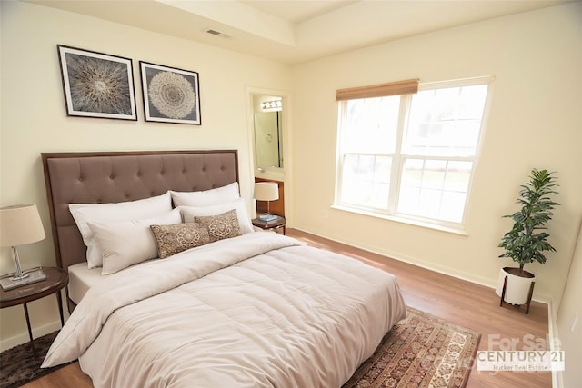 bedroom with hardwood / wood-style floors