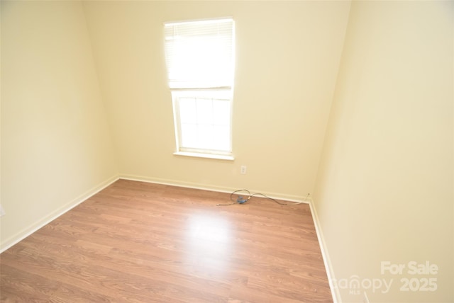 spare room featuring light hardwood / wood-style floors