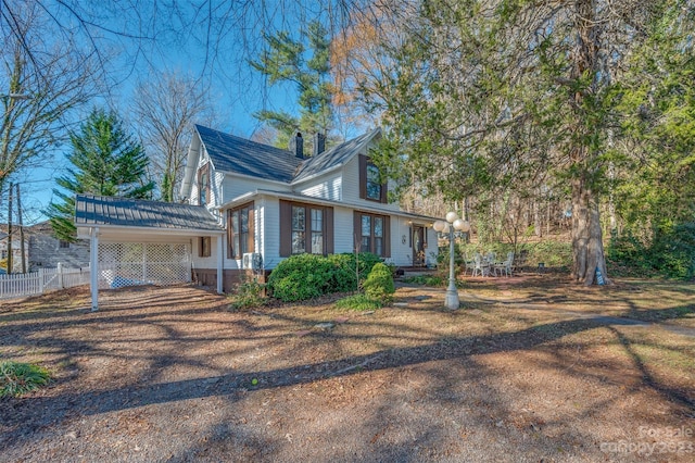 view of side of property featuring a carport