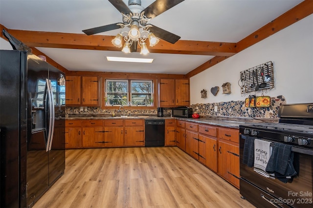 kitchen featuring ceiling fan, backsplash, black appliances, sink, and light hardwood / wood-style flooring