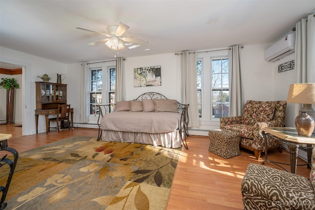 bedroom featuring ceiling fan, baseboard heating, hardwood / wood-style floors, and a wall unit AC