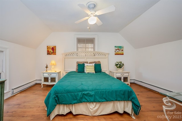 bedroom featuring ceiling fan, a baseboard heating unit, vaulted ceiling, and hardwood / wood-style floors